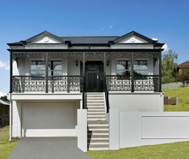 White two-storey home with veranda and wrought-iron railings